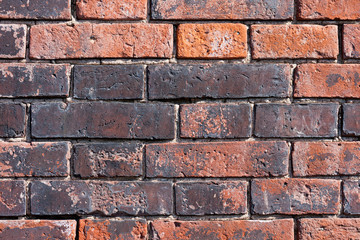 Old weathered red brick wall as background