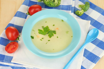 Diet soup with vegetables in pan on wooden table close-up