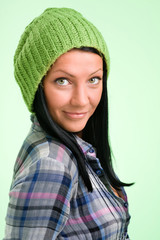 smiling woman in a green cap on green