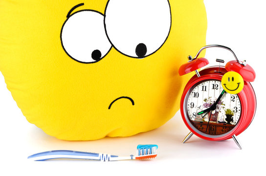 Big yellow smiley, toothbrush and an alarm clock