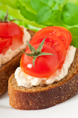 Warm bread tomatoes, cream cheese and basil