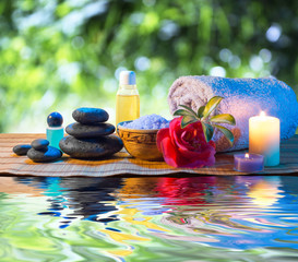 stones, candle camellia oil salt towel on water