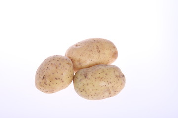 Fototapeta na wymiar Three unpeeled potatoes