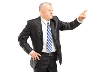 Angry mature man gesturing with finger