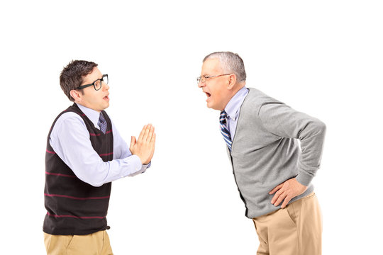 Mature man shouting at a man who is begging