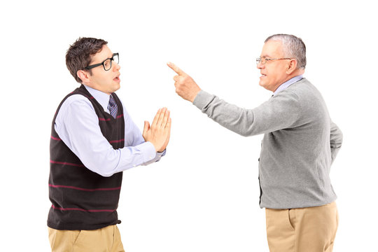 Young Man Begging An Older Angry Man