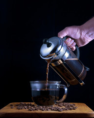 Pouring coffee from a coffee press