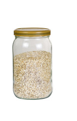 Glass jar filled with raw oats on white background