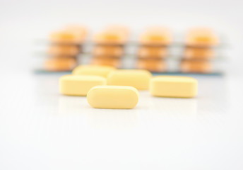 Yellow tablet and blister pack background