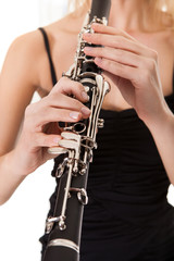 Beautiful young woman playing clarinet