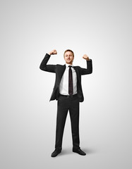 Excited young businessman celebrating victory