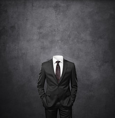 man without head on dark concrete background