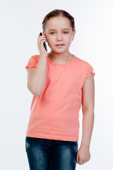 Small and beautiful girl with a phone