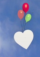 Obraz na płótnie Canvas Three colourful ballons with a heart flying in the sky