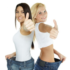 Beautiful girls are proud to lose weight - showing thumb up