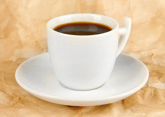 Cup of strong coffee on beige background