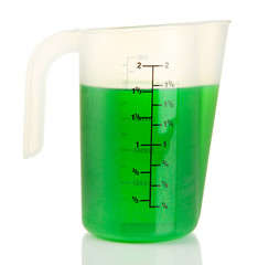 Measuring cup with green liquid isolated on white