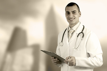 Smiling medical doctor with stethoscope on the hospitals backgro