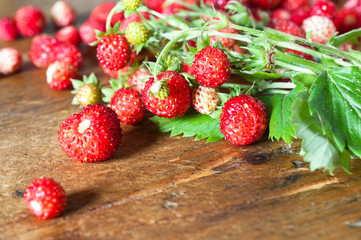 Wild strawberries on wooden background