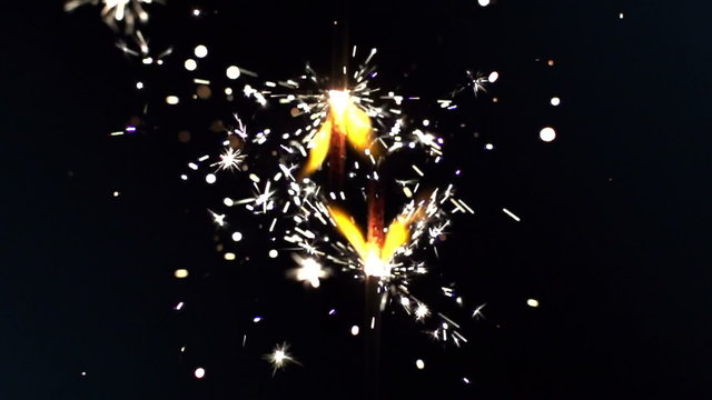 a sparkler being ignited making abstract pattern in slow motion