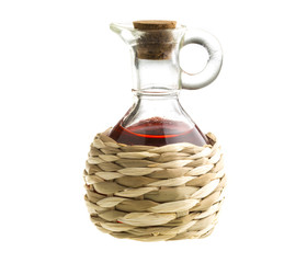 Small decanter with red wine vinegar isolated on the white