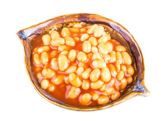 Marinated haricot beans in tomato sauce with shallots on a plate