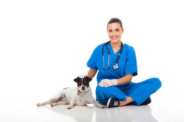 caring vet doctor sitting with pet dog