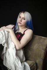 Beautiful Young Goth Woman with Blue Hair and Red Corset