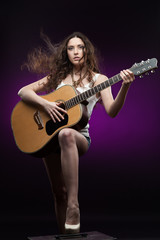 Fototapeta na wymiar sexy girl holding guitar