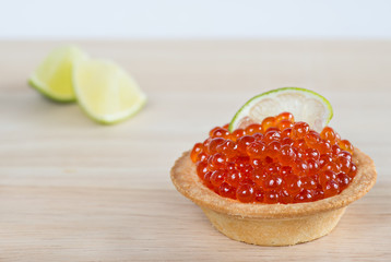 Tartlet with red caviar and lime