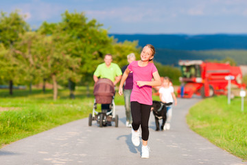 Fototapeta premium Family with children and dog having walk