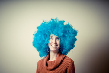 beautiful girl with curly blue wig and turtleneck