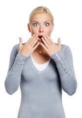 Shocked woman covers her mouth with hands