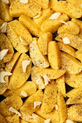 Raw potatoes with spices ready to be roasted