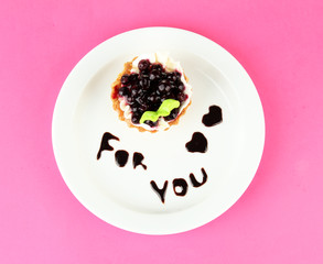 Sweet cake with blackberry and chocolate sauce