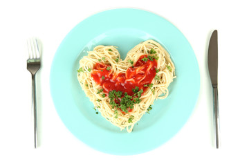 Cooked spaghetti carefully arranged in  heart shape and topped