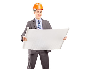Smiling young engineer posing with a blueprint