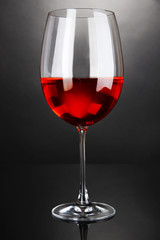 Red wine glass on grey background