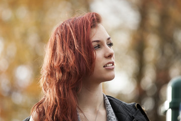 Young Woman with Beautiful Auburn Hair with Autumn Background - obrazy, fototapety, plakaty