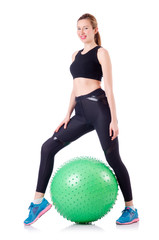 Young woman with ball exercising on white