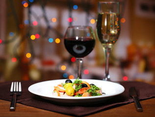Tasty salad on dark background with bokeh  defocused lights