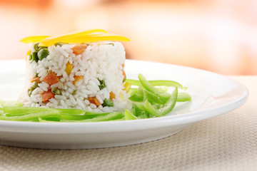 Delicious risotto with vegetables on table in cafe