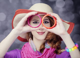 Beautiful red-haired girl in hat at bokeh background