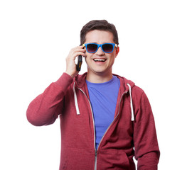 Style young man in sunglasses with mobile