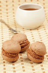 Three cocoa dough sponge drops with cream, cup of tea