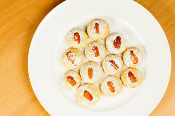 Coocies with almond nuts and sugar powder on plate