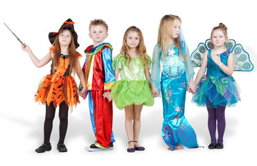 Children in carnival costumes stand holding hands