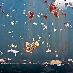 Rusty metal surface with an old peeling paint