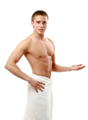 A nude young man covering himself with a towel