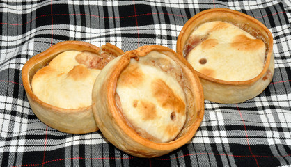 Scottish Meat Pies With Tartan Background © philip kinsey